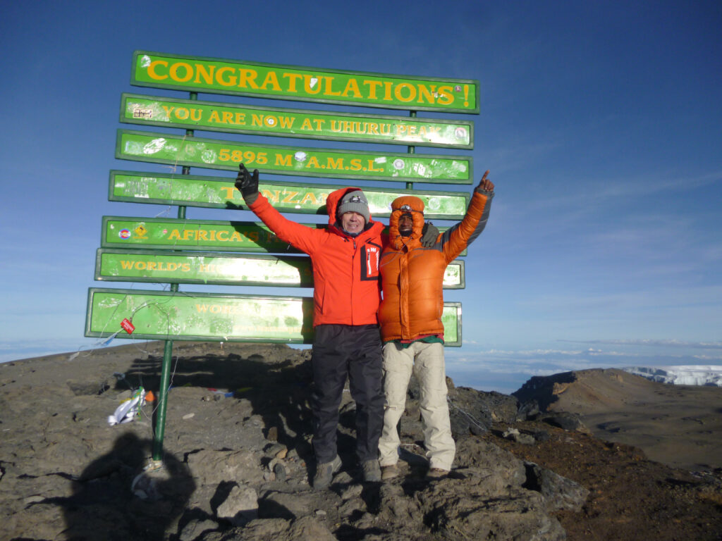 Roy Davies summits Uhuru Peak, the highest point of Mount Kilimanjaro in Tanzanaia